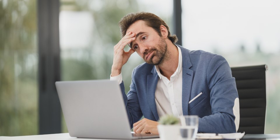 Founder alone at a desk at the end of the day, working through what still needs him